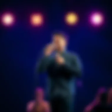 Ali Jr stands on stage holding a microphone, engaging the audience with laughter and energy.