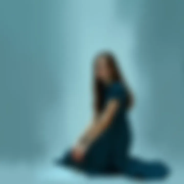 Heartbreak Art A painting depicting a young woman sitting alone with a sad expression, surrounded by shades of blue and gray, symbolizing heartbreak.