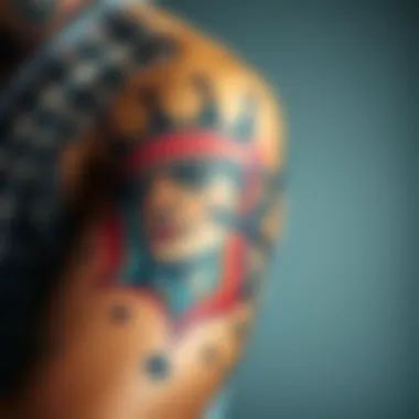 A close-up view of a colorful inner bicep tattoo featuring a detailed portrait of a person, showcasing the artistry and expression of tattoo culture.