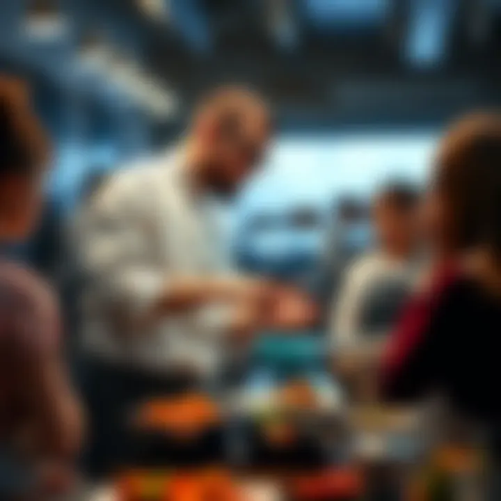 A chef named Joey engages in cooking while speaking to a small group, showcasing the art of communication in the kitchen.