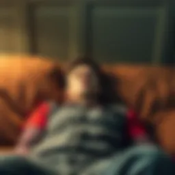 A person lying on a couch with minimal effort, looking defeated and uninterested in work, reflecting the idea of laziness.