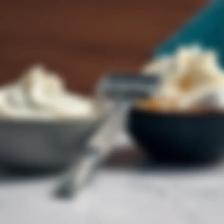 A close-up of a traditional razor next to a bowl of shaving cream, emphasizing the classic grooming method.